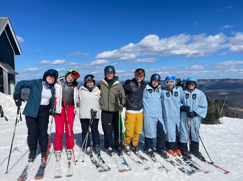 Members of Columbia's Ski and Snowboard Club on top of mountain.
